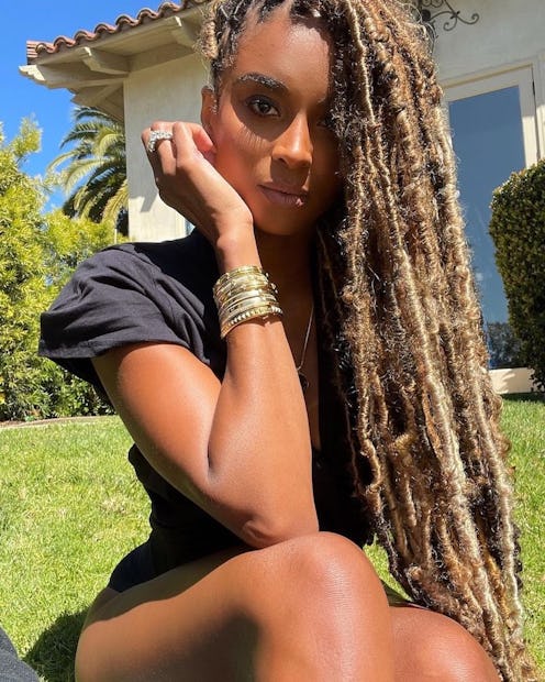 Ciara posing outside with long blonde locs