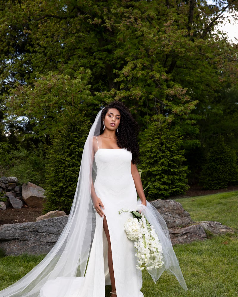 A woman posing in Christian Siriano bride gown
