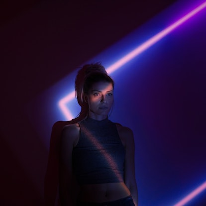 Young woman with 2 ruling planets in neon lights.