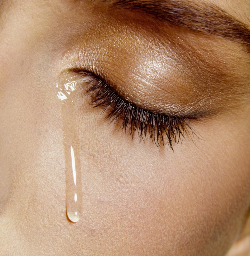 A woman has a single tear roll down her face. Asking "Why can't I cry?" or "Why can't I cry anymore?...