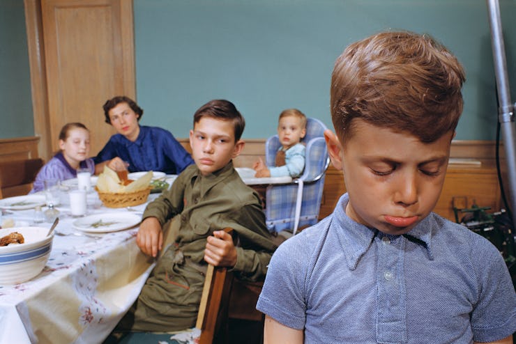 boy sad at dinner