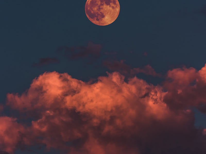 The full moon above pink clouds