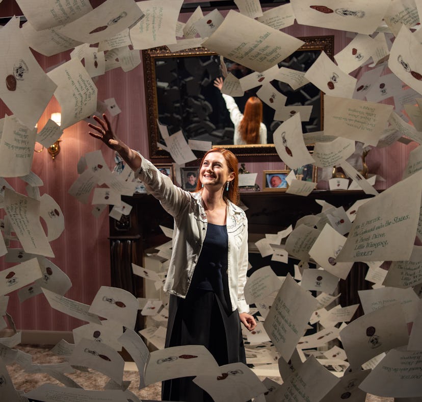 Bonnie Wright from the 'Harry Potter' films reaches for a Hogwarts letter in a photo opp at the Warn...