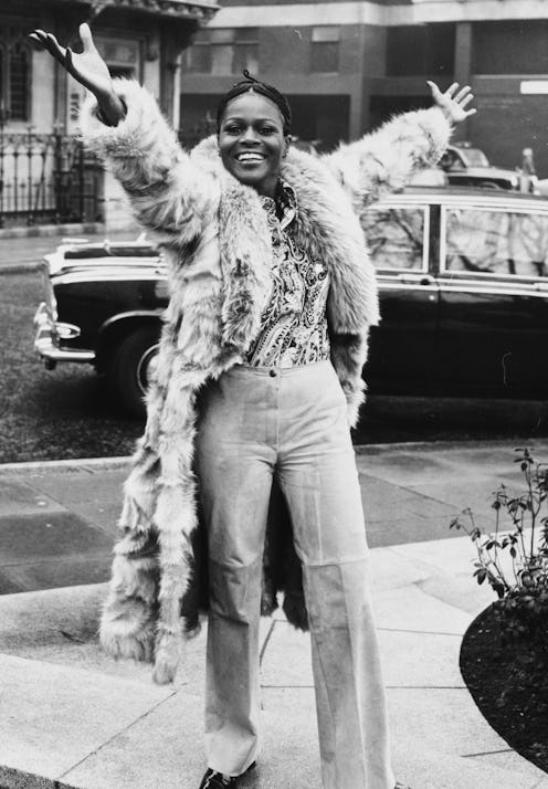 Portrait of Academy Award winning American actress Cicely Tyson smiling and raising her arms in the ...