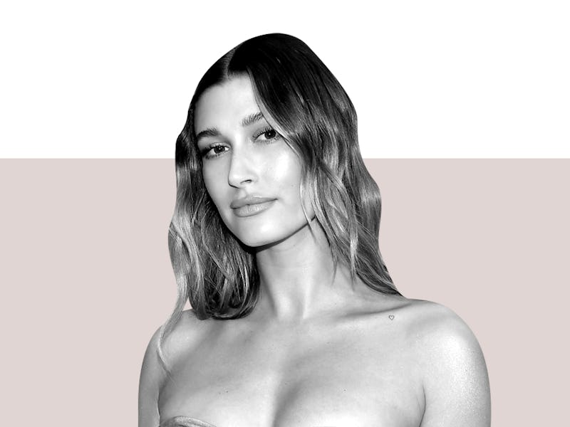 A black and white photo of Hailey Bieber on a light pink and white background