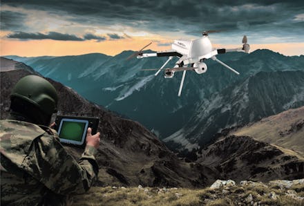 Soldier operating drone in mountainous region