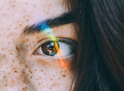 Young woman with rainbow light across eye to show when your dreams will be the most vivid, per your ...