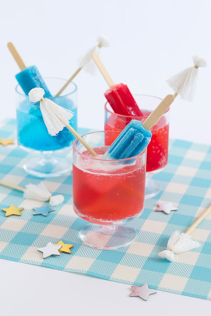 red, white, and blue cocktail made with a popsicle and tassel garnish