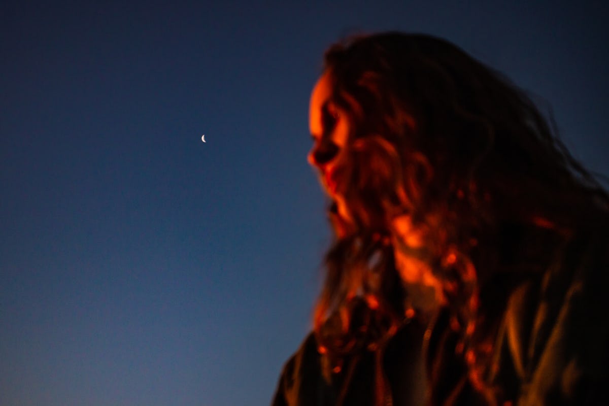 Young woman in the moonlight to show when your dreams will be the most vivid, per your zodiac sign.