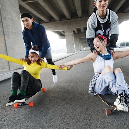 Young group of friends skateboarding.