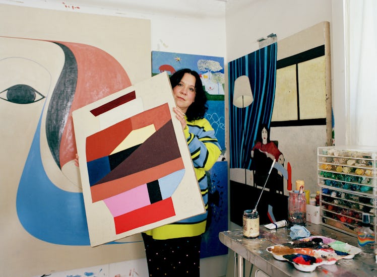 Clare Rojas holds a painting 