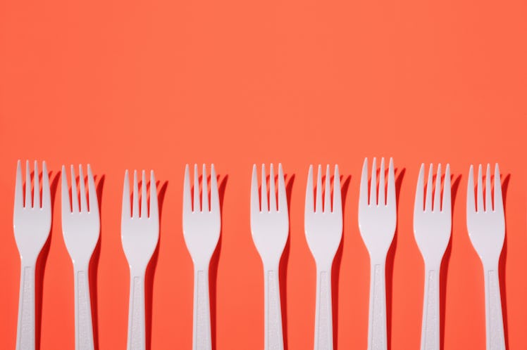 Plastic forks on red background