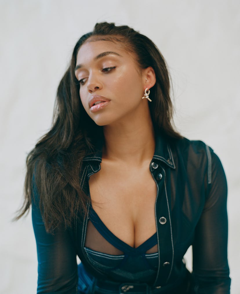 Model Lori Harvey poses in a denim outfit for Bustle.