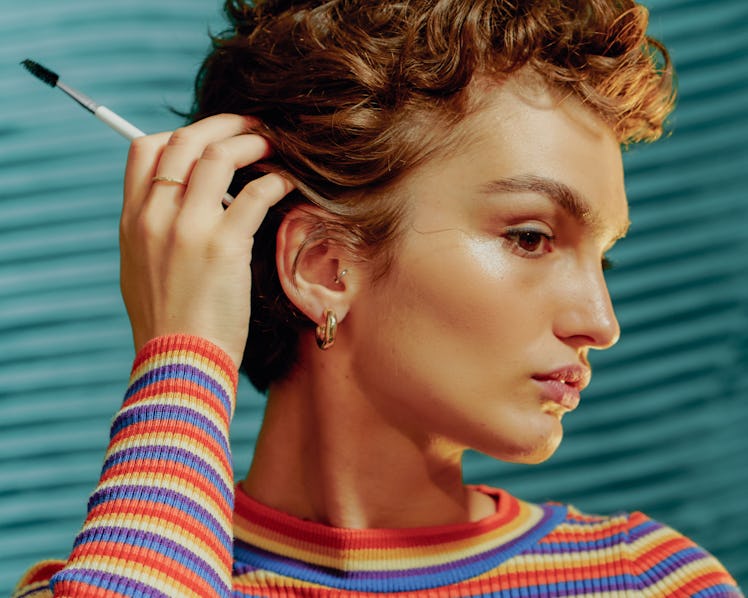 Young Pisces woman tucking her hair.