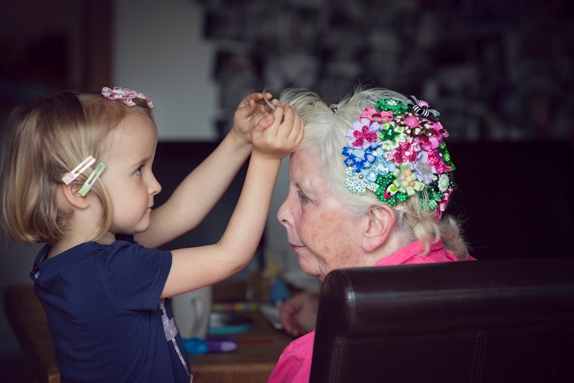 Grandchild decorating grandmother's hair