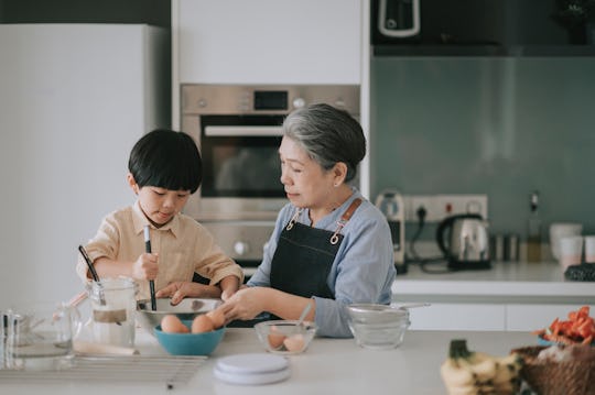 grandmother and grandson baking in the kitchen