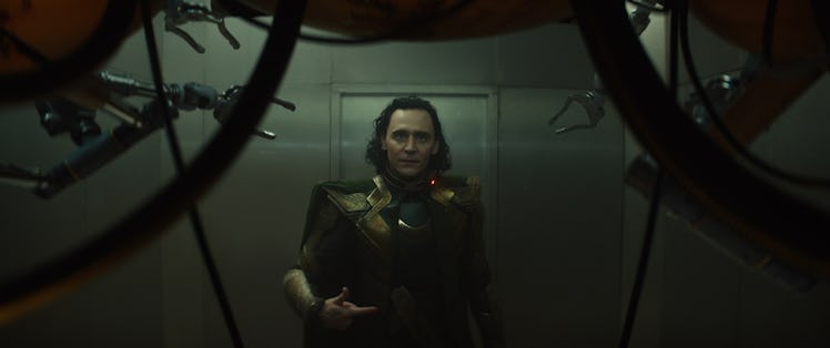 Tom Hiddleston wearing green and gold armor in Loki Episode 1