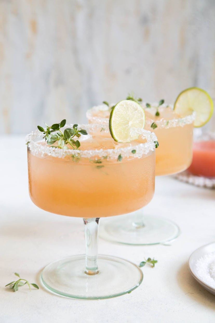 honey thyme margarita with lime wedge and salted rim