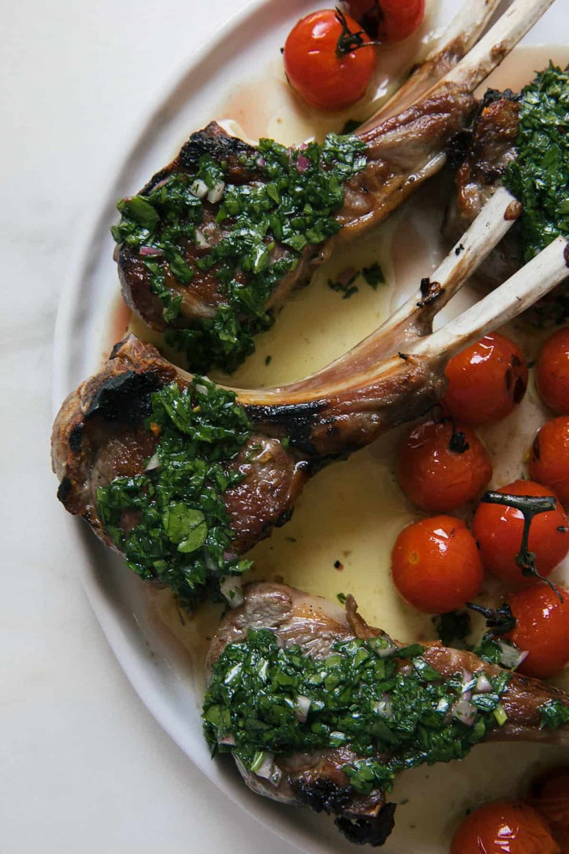 overview shot of chimichurri lamb chops with small tomatoes
