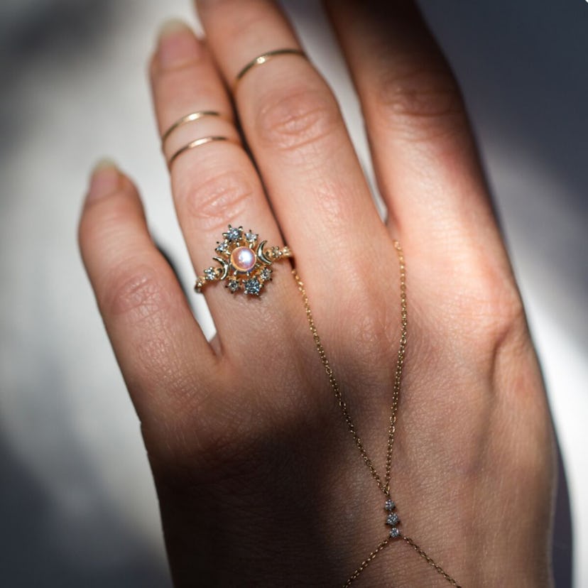 A model wears a moonstone engagement ring.