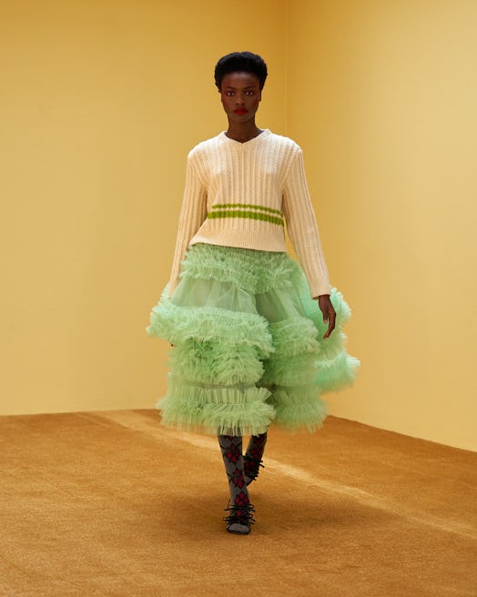 Model wearing a white jumper and a mint green puffy skirt by Molly Goddard 