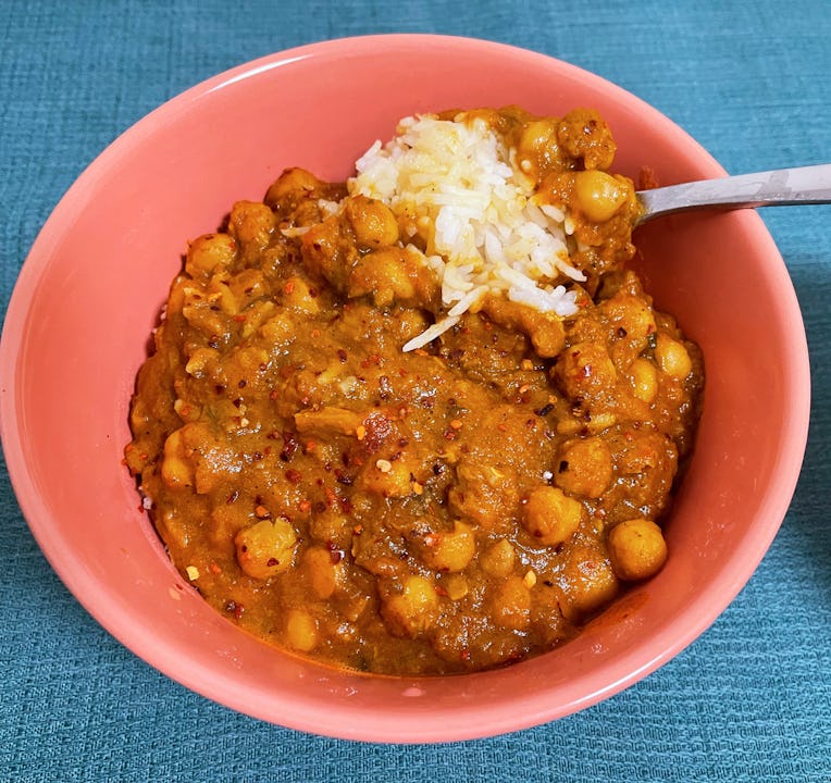 A bowl of chana masala on top of white rice.