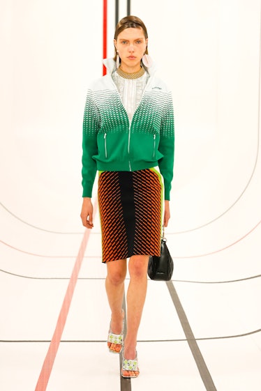 Model wearing a sporty green jacket by Miu Miu