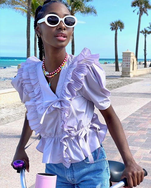 Model wearing a purple top in a photo for Shopbop.