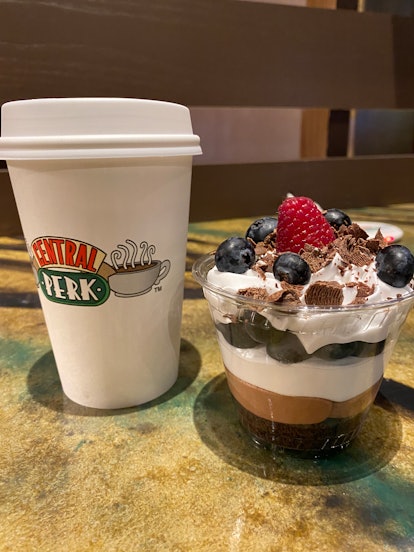 A Central Perk Café coffee cup sits next to Rachel's trifle, which are available at the Warner Bros....
