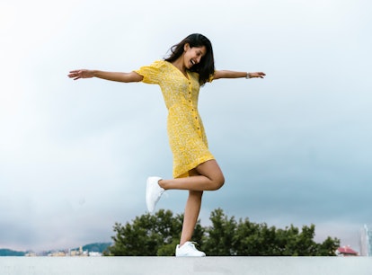 Young woman twirling in a floral summer dress, ready to post on Instagram with a sweet caption.