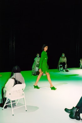 Model wearing a green jacket, green skirt, and green heels by Bottega Veneta 