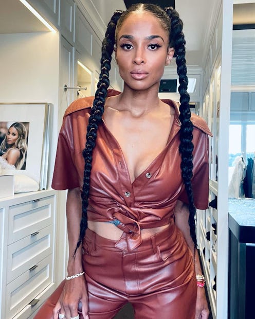 ciara with long dark braids and a maroon leather jumpsuit on