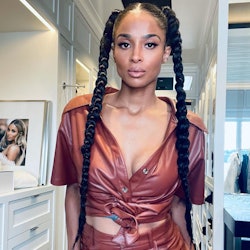 ciara with long dark braids and a maroon leather jumpsuit on