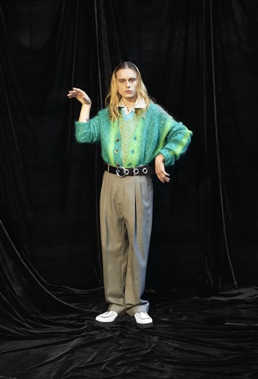 Model wearing oversized shoes and pants with a multi-colored green jumper by Marni
