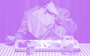 Man with napkin tucked into collar.