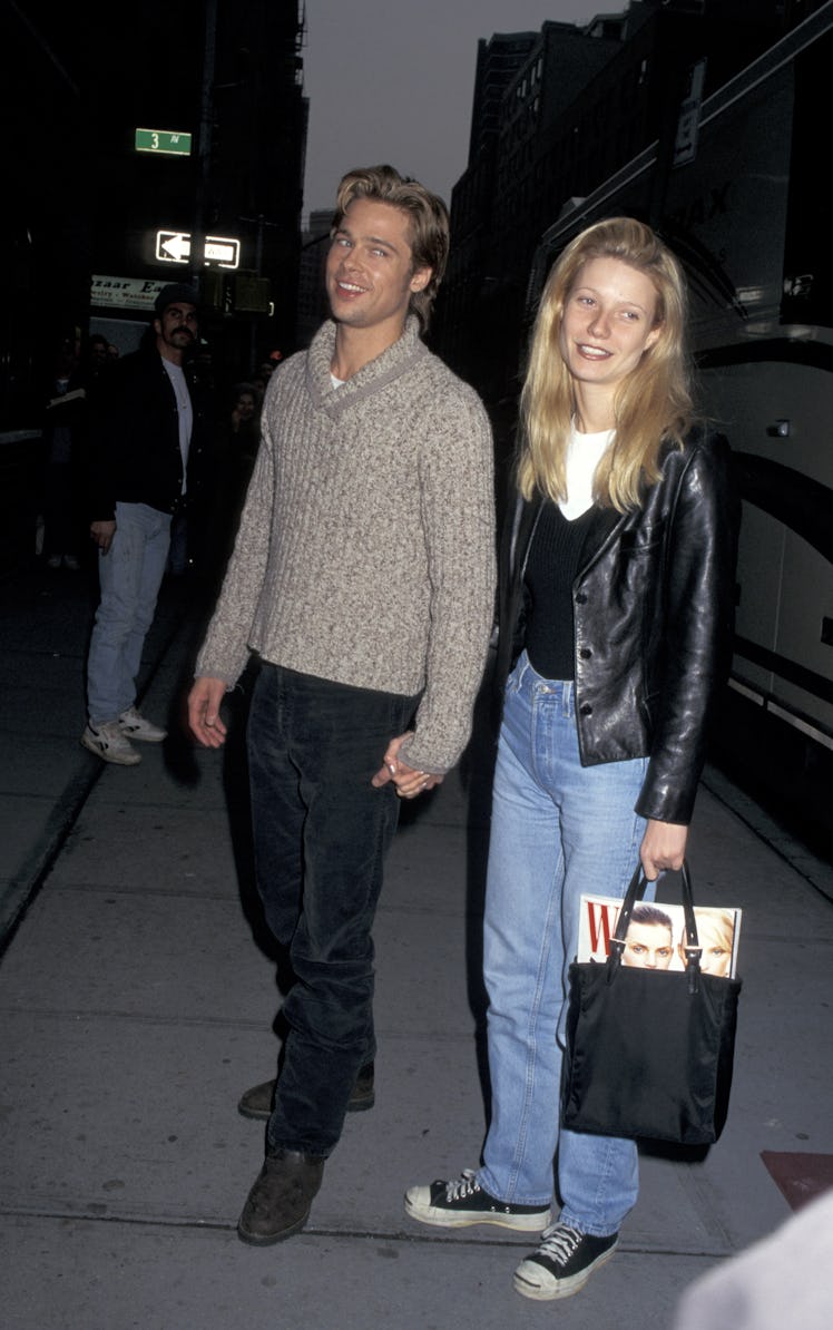 Brad Pitt and Gwyneth Paltrow smiling and holding hands