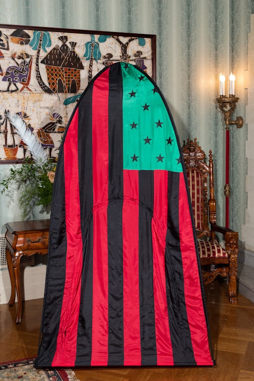 A tent with the American flag in green, red and black 