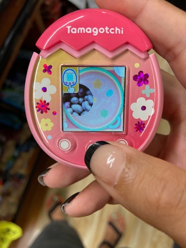 A pink Tamagotchi Pix is pictured displaying a photo of potatoes