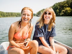 2 young friends out on the lake, having fun on a boat in need of Instagram captions for boating.