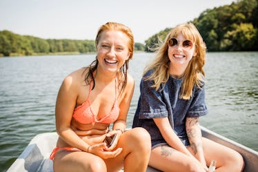 2 young friends out on the lake, having fun on a boat in need of Instagram captions for boating.