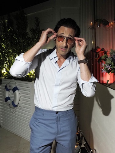 Adrien Brody touching his sunglasses