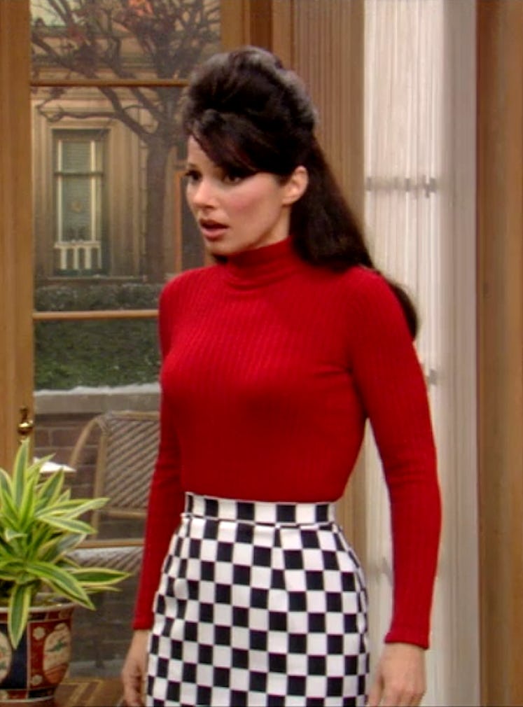 The Nanny's Fran Fine wearing a red long sleeve turtleneck tucked into a black and white checkerboar...