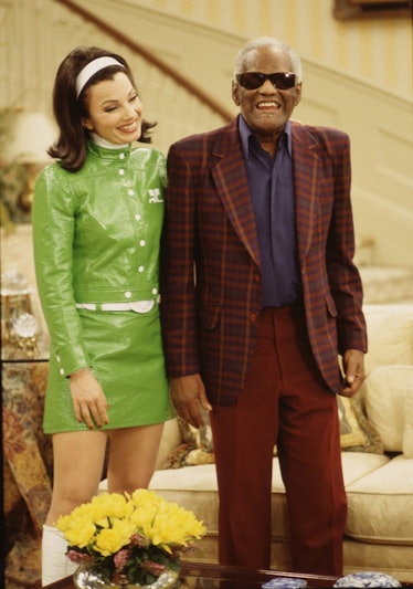 The Nanny's Fran Fine wearing a matching green jacket and skirt set with white gogo boots and a whit...