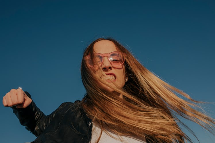 Mad young woman about to punch the camera to show how her zodiac sign shows anger.