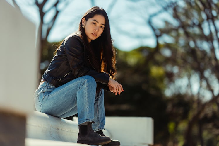 Mad young woman sitting on a step, showing how she deals with anger, per her zodiac sign.