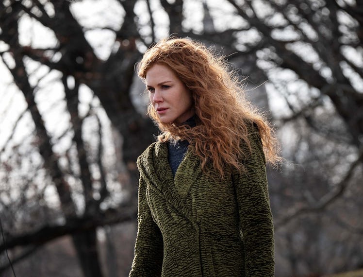 Nicole Kidman looking longingly into the distance with trees in the background 
