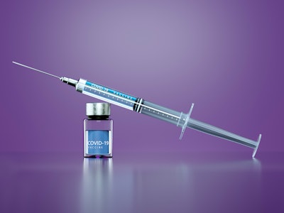 Syringe with COVID-19 vaccine on purple background