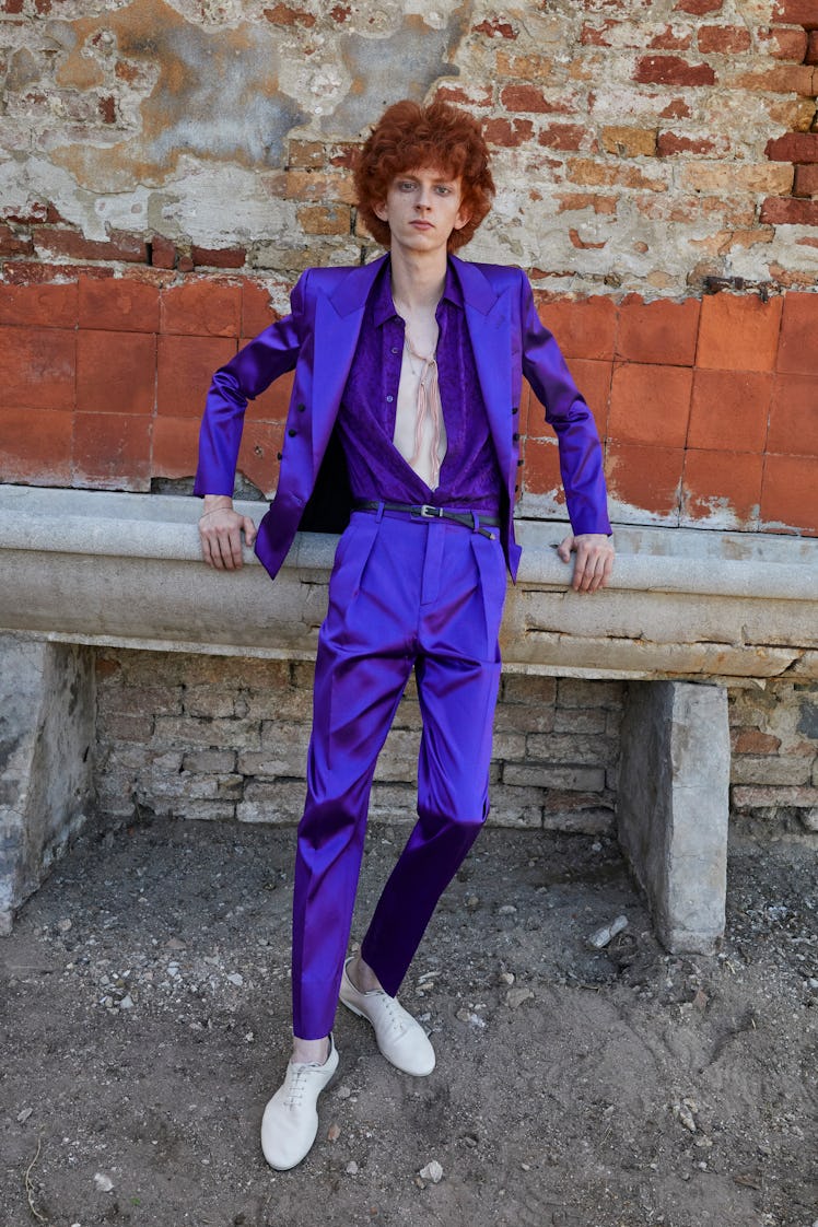 A model posing in a Saint Laurent blue shirt and suit at Men’s Fashion Week Spring 2022