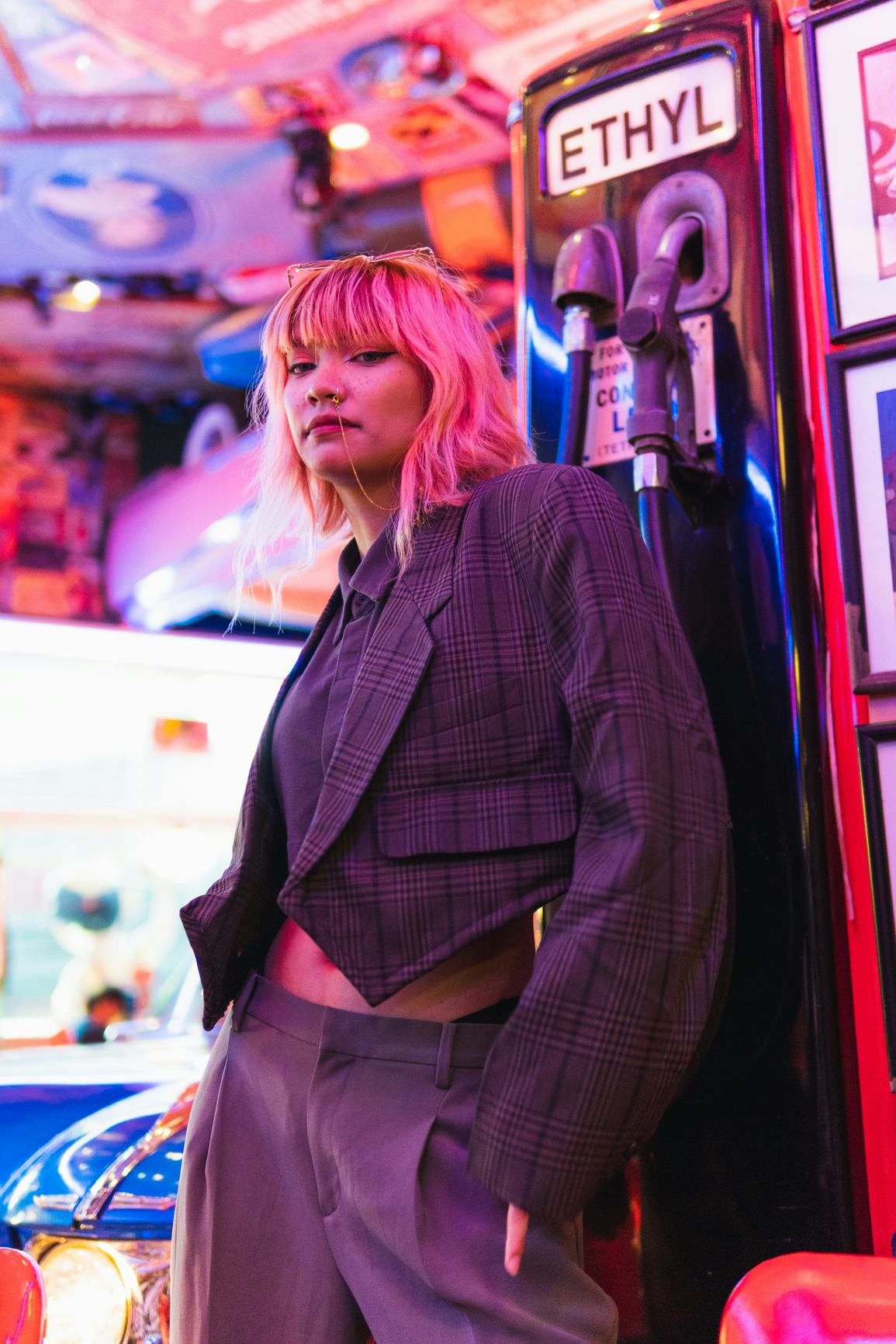 Young woman with pink hair at a gas station, showing how the July 2021 full moon will affect her zod...