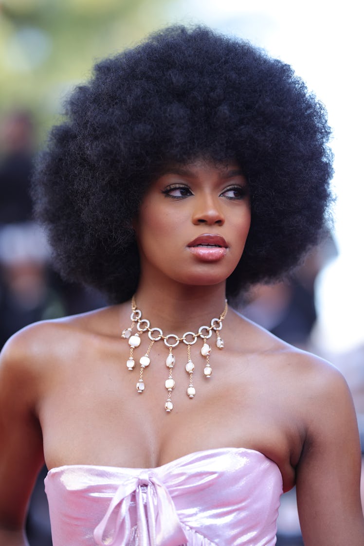 Didi Stone in a pink corset dress and a golden chain and pendant necklace at the Cannes Film Festiva...